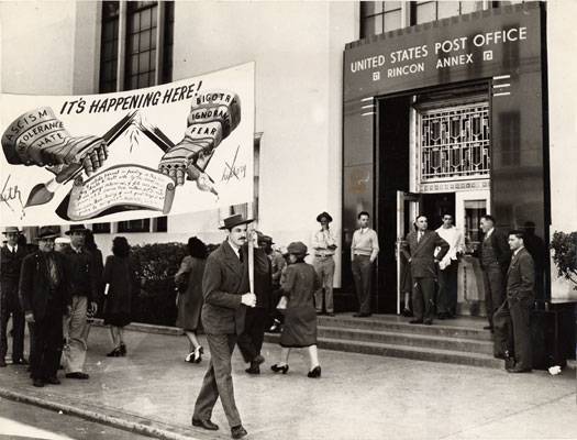 Artist Anton Refregier and C.I.O. longshoremen union members carrying a banner in protest for the covering up of a section of a mural at the Rincon Annex Post Office May 14 1948 AAK-0709.jpg