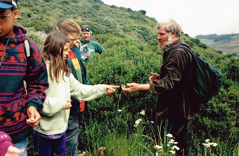 David-schooley-and-kids-on-SB-Mtn-looking-at-flowers-1994.jpg