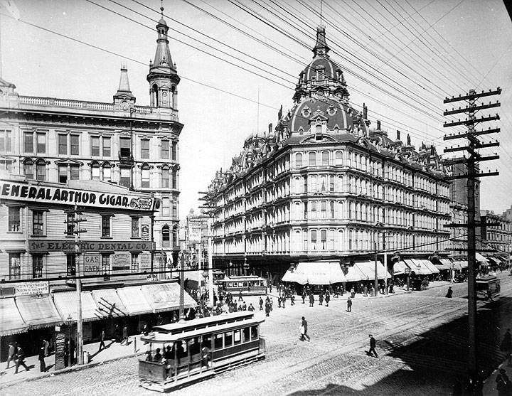 Baldwin-Hotel-Market-and-Powell-Sts-w-cable-cars-and-pedestrians-c-1880s.jpg