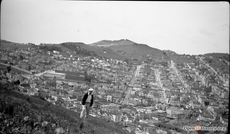 File:1930s View west, overlooking Noe Valley, with elevated railway. St Pauls Catholic Church at far right. In lower right corner, 29th-Mission St. car barn, Lyceum Theatre. Fairmount School wnp14.1107.jpg