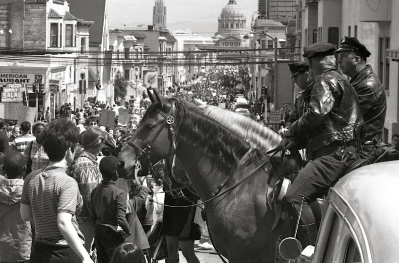 Mounted policemen watch a Vietnam War protest march in San Francisco, April 1967.jpg