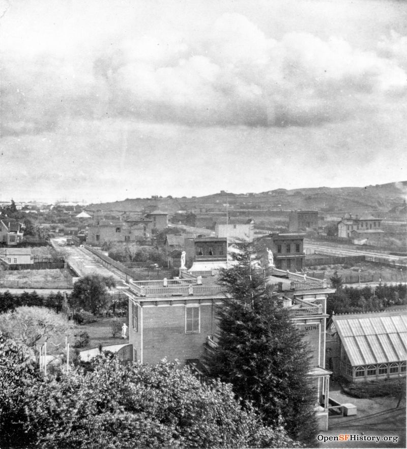 East view from Woodwards c 1869 Woodward's Gardens, elevated view east across Mission District to Potrero Hill showing rear of museum and conservatory. Erie Street on other side of Mission wnp26.639.jpg