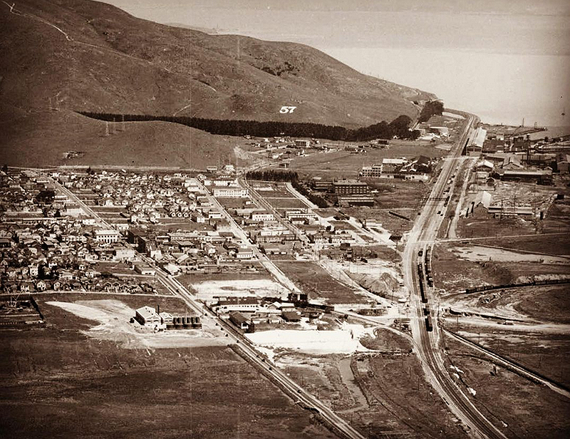 Aerial view from 1929. Peck’s Lots and 57 Hill. Southern Pacific Bayshore Cutoff is lined with heavy industry. At the middle left is Southern Pacific’s South San Francisco station.jpg