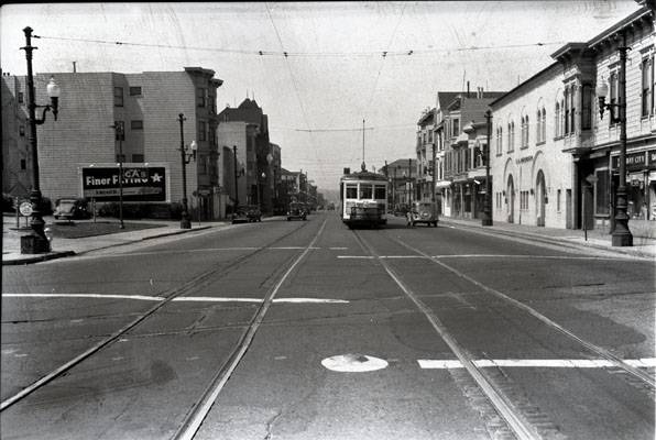 25th and Valencia streets looking south at southbound -9 line car and Southern Pacific crossing containing original cable car slot 1942 aax-0116.jpg