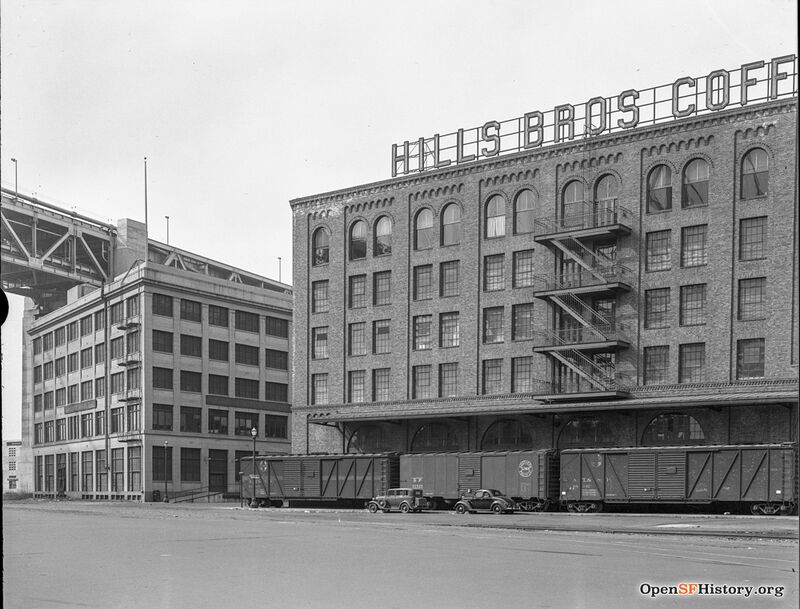 View west across Embarcadero to bridge, Hills Brothers Coffee Plant with freight cars alongside 1938 opensfhistory wnp14.2714.jpg